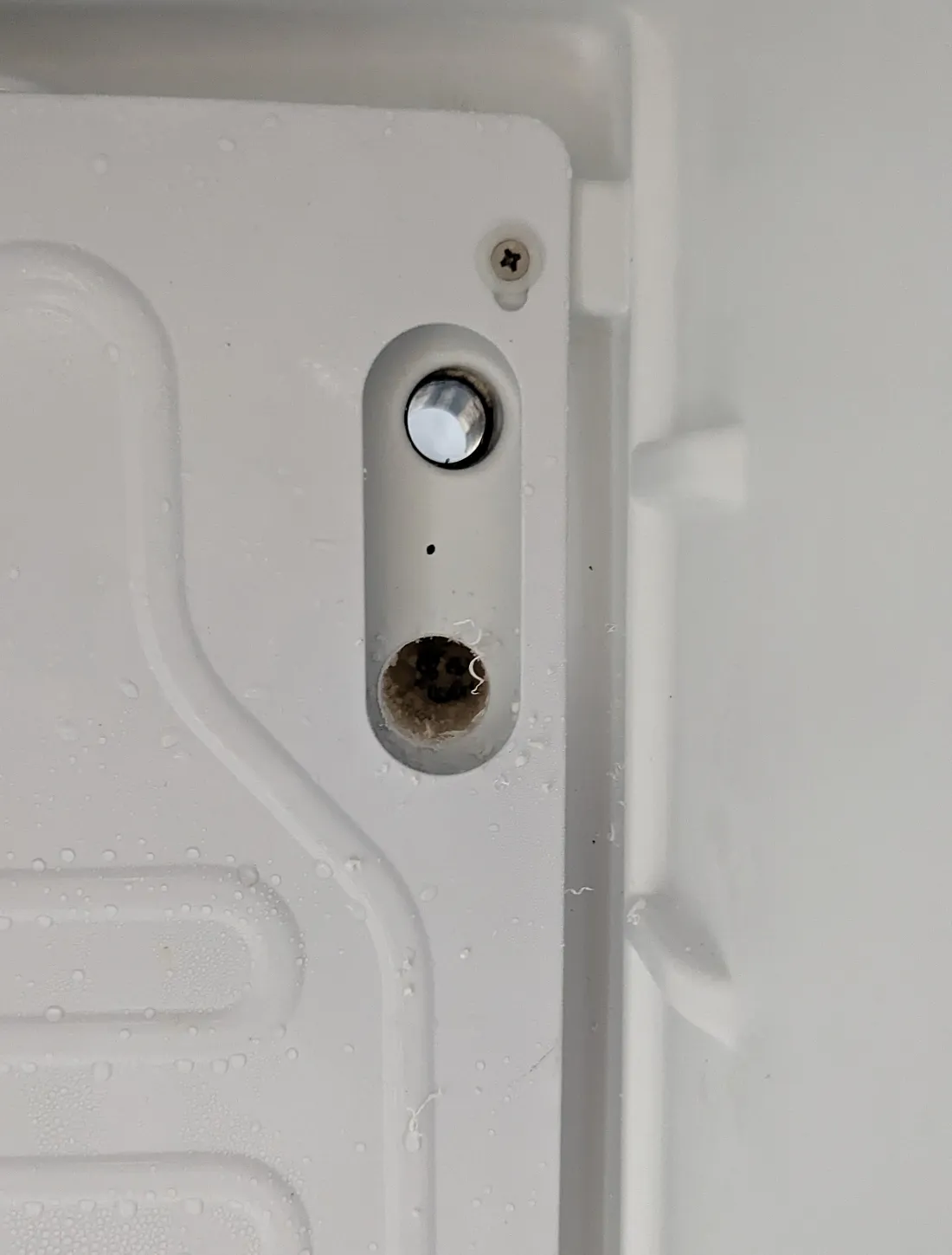 interior of the fridge, close-up of a pill-shaped cutout in the cold plate